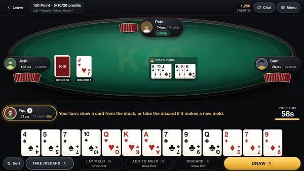 A K40 Online Kalooki table on a computer in the dark look, with three opponents round a green table, the stock and discard piles, one player's melds laid down and a thirteen-card hand along the bottom